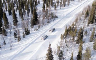 Two campervans parked in the snow during a Winter Olympics 2026 campervan trip in the Italian Alps.