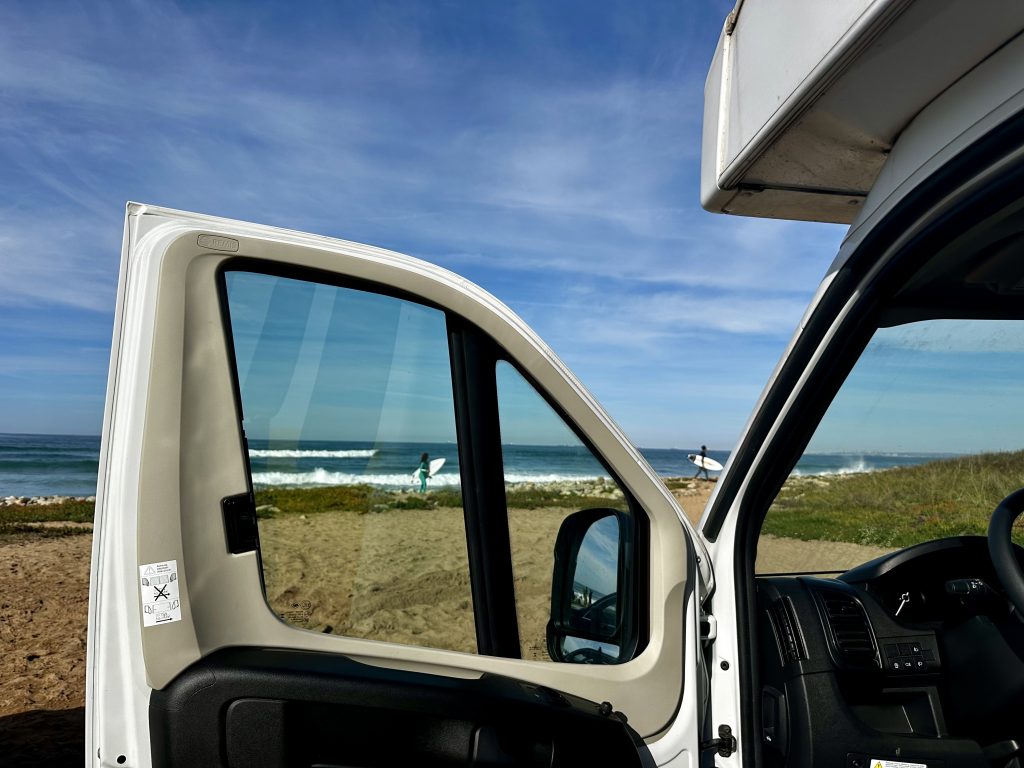 Indie Campers campervan parked on a beach during a coastal roadtrip.