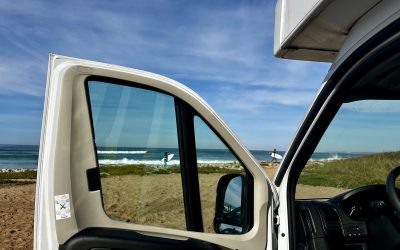 Indie Campers campervan parked on a beach during a coastal roadtrip.