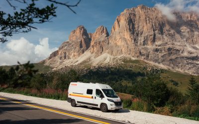 Campervan parked at sunrise beside Lago di Braies with Seekofel mountain reflection in turquoise water