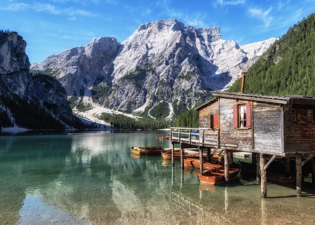Italian Alps campervan road trip at Lago di Braies with turquoise water and mountain reflections
