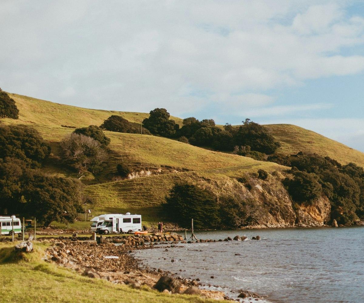 Campervans parked at a coastal campsite in New Zealand