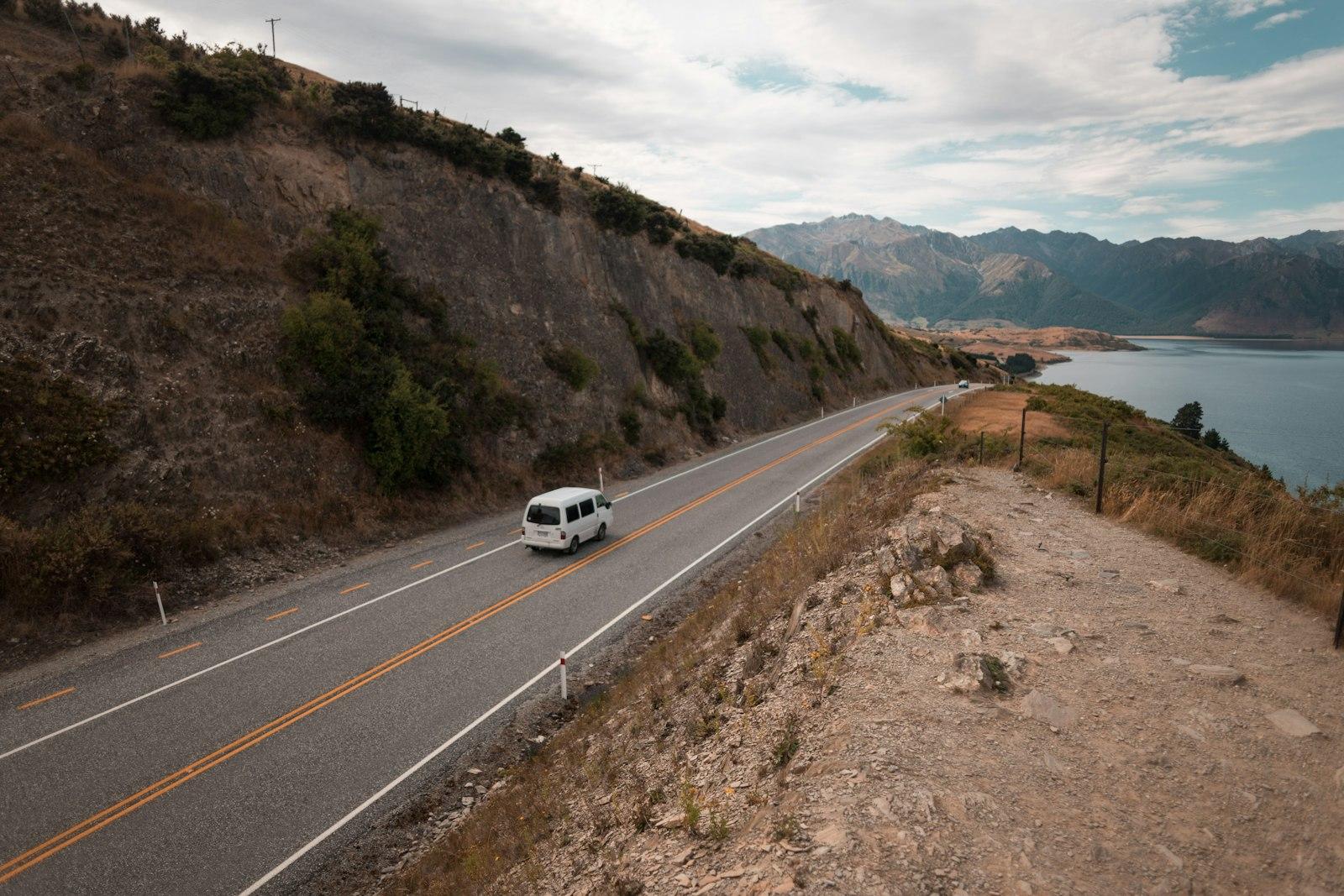 Van driving along a coastal highway in New Zealand