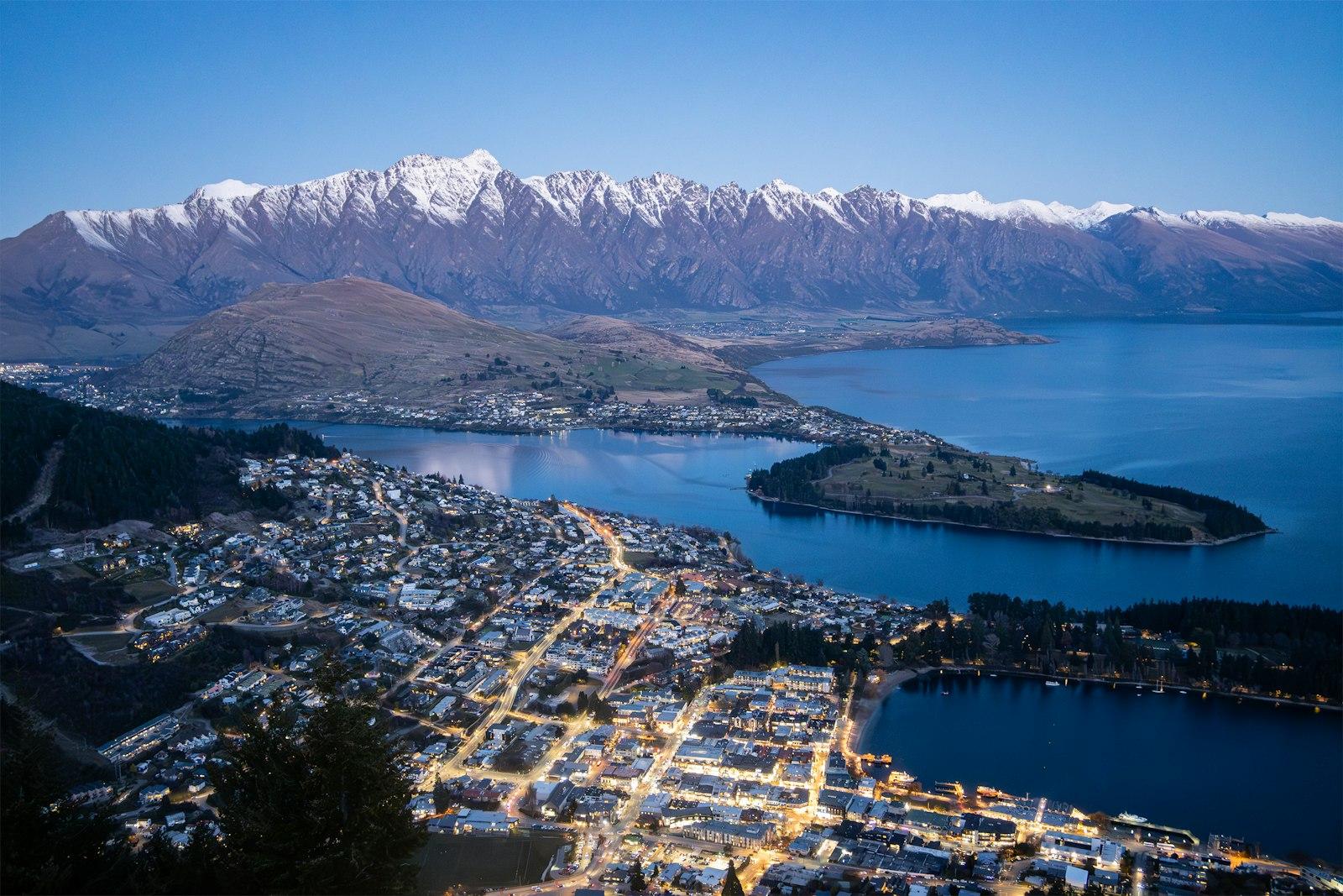 Queenstown and Lake Wakatipu at dusk below The Remarkables