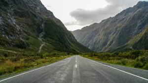 Milford Road winding between mountains in Fiordland, New Zealand