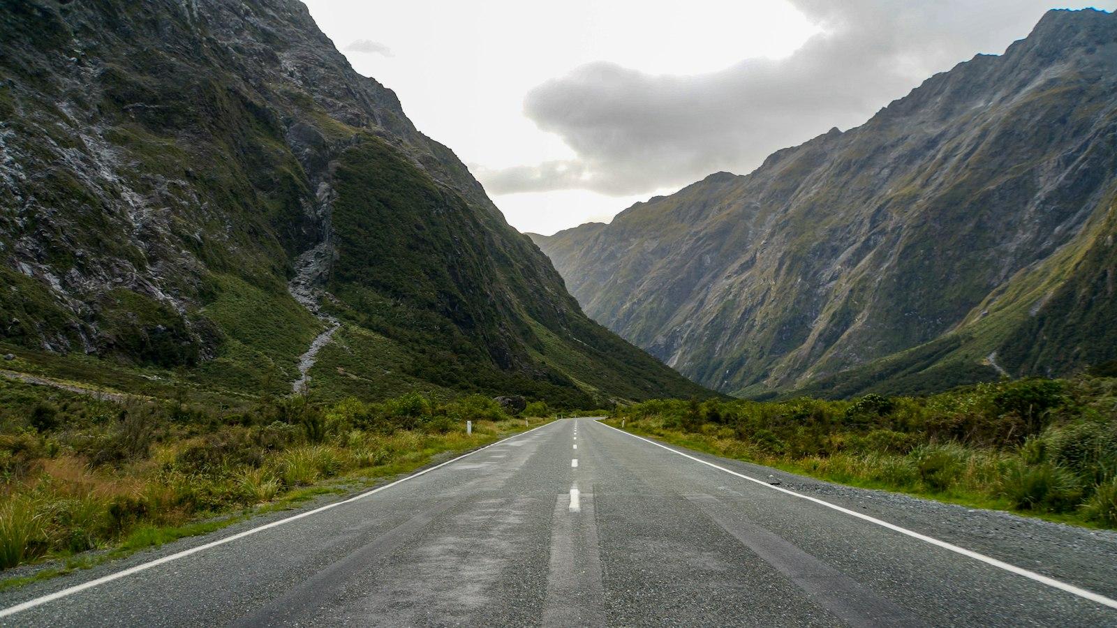 Milford Road winding between mountains in Fiordland, New Zealand
