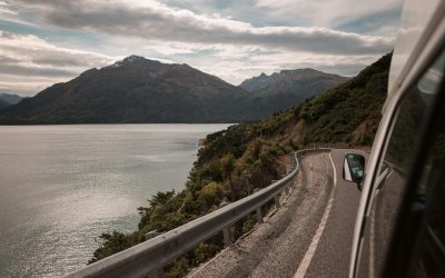 View from a campervan window along a lakeside road in New Zealand