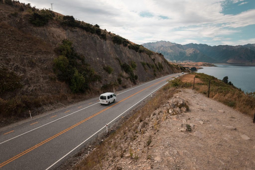 Van driving along a coastal highway in New Zealand