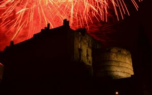 Fireworks lighting up the sky above Edinburgh Castle at night